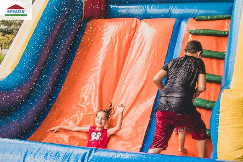 a little girl is playing in a bouncy castle
