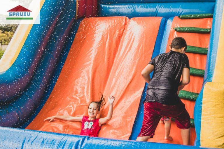 a little girl is playing in a bouncy castle